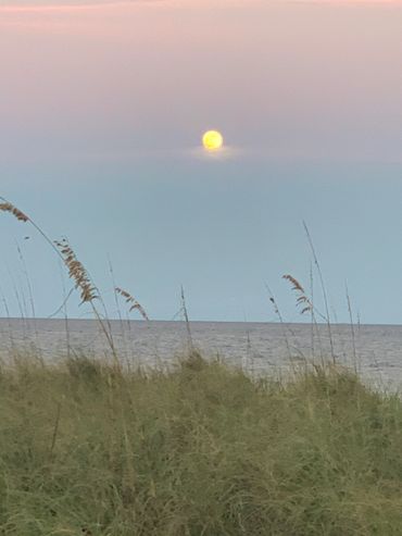 Full moon glowing against night sky