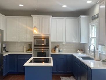 Two tone kitchen cabinet painting transformation by Comprehensive Painting in Wilmington