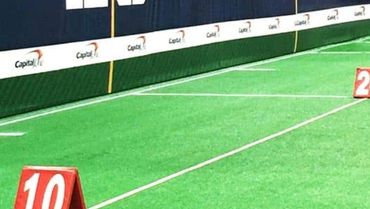 Markers showing yard lines on a football field.