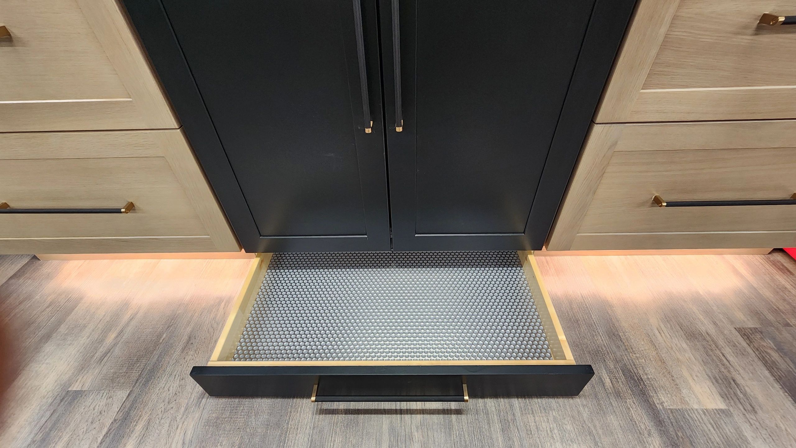 Open kitchen drawer with honeycomb-style mat inside.