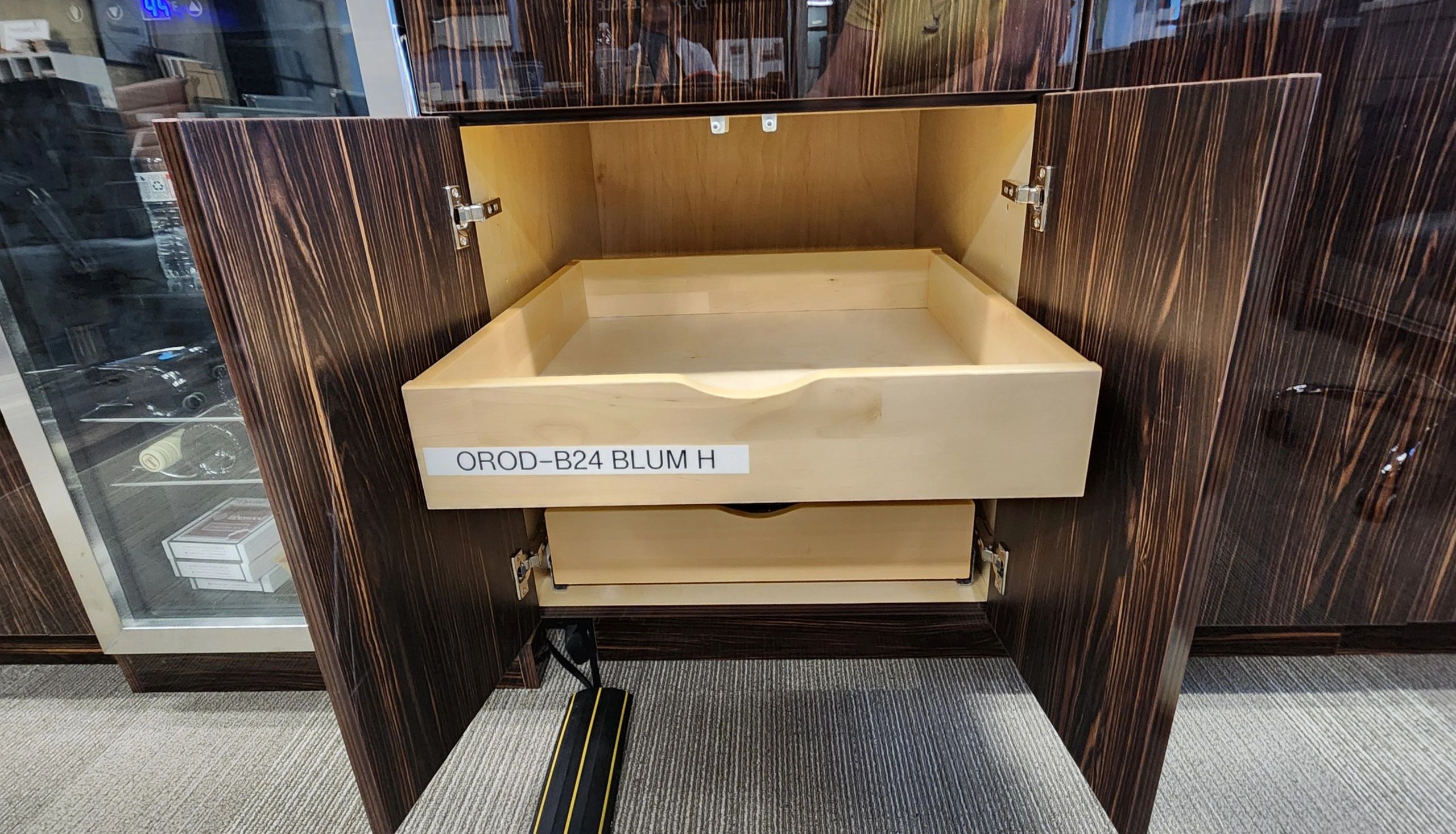 Open wooden cabinet with a labeled drawer.