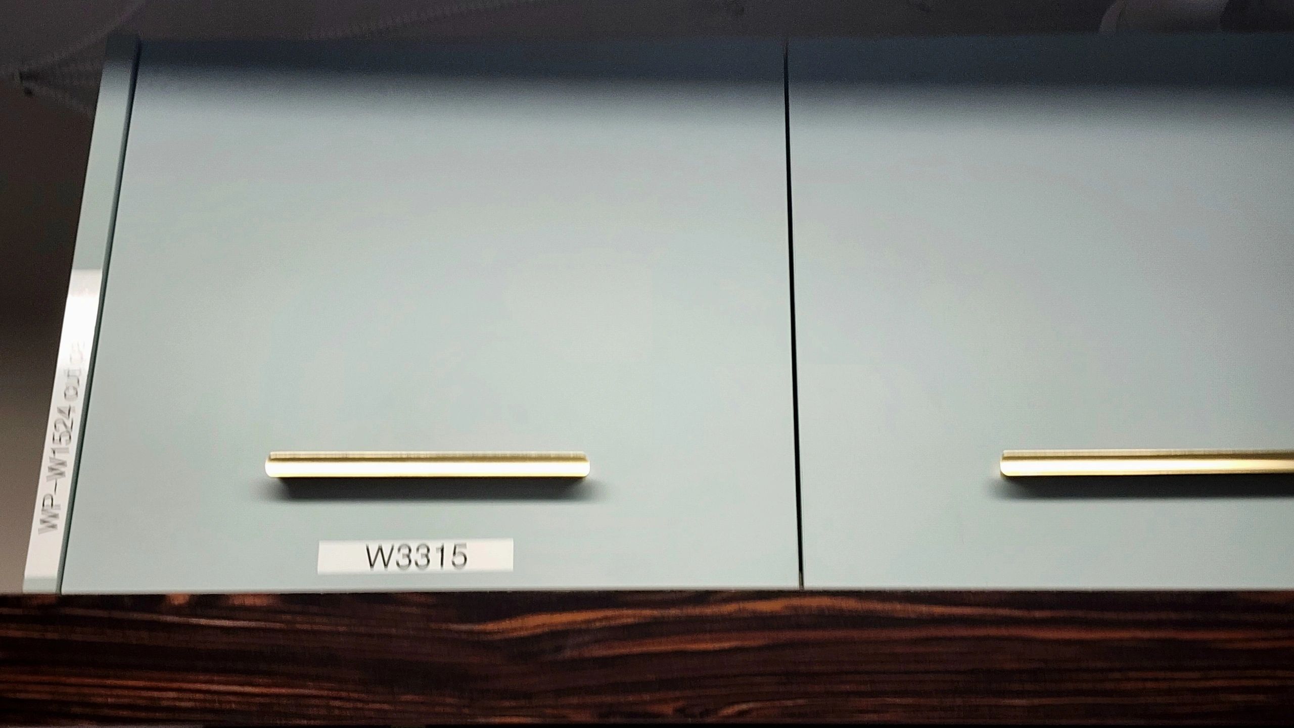 Light blue cabinet doors with gold handles.