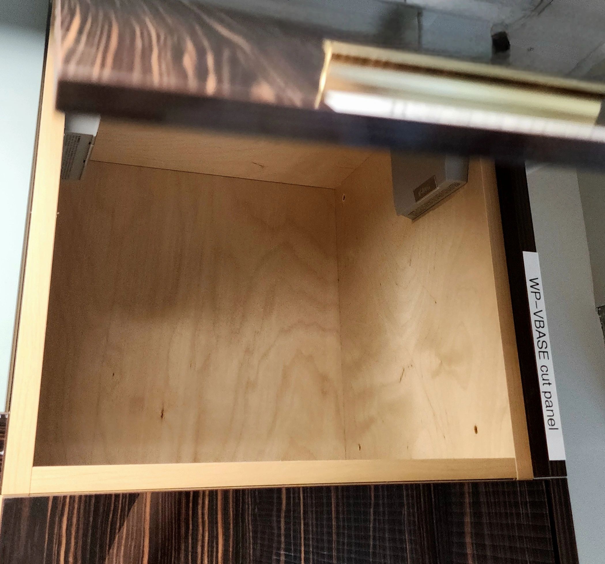 Empty wooden drawer with reflections on top.