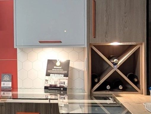Kitchen countertop with wine rack and brochures.
