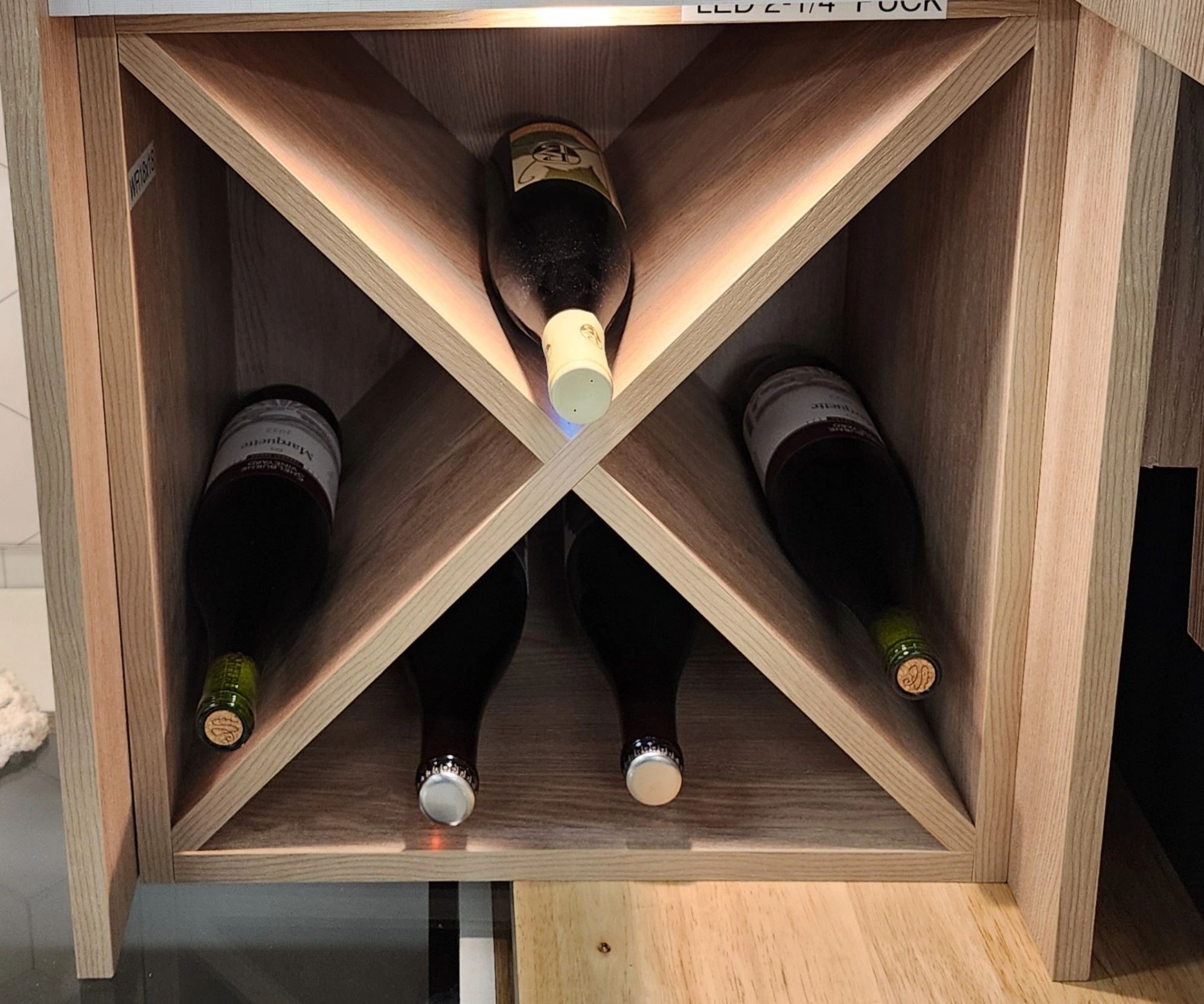 Wine bottles stored in a wooden rack.