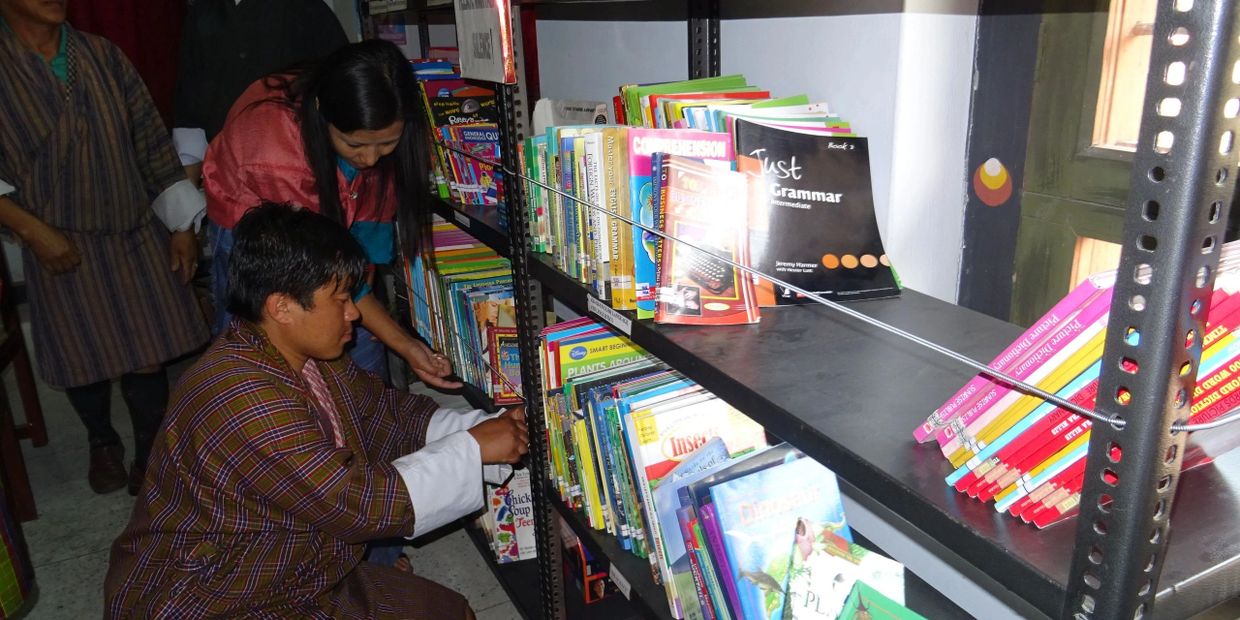 A group of teachers in a school in Bhutan implementing falling hazard mitigation techniques