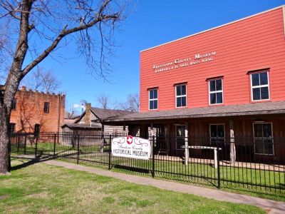 Historical museum building with clear blue sky.