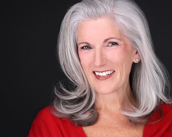 mature woman with silver hair  in red top