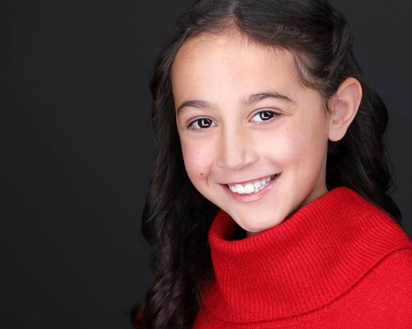 little girl wearing red sweater