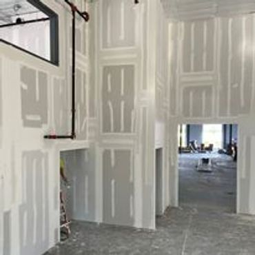 Interior walls under construction with drywall installed but unfinished.