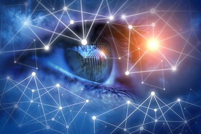 Close-up of a blue eye with digital network connections overlay.