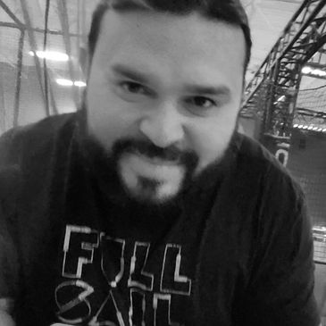 Smiling man with beard wearing a Full Sail t-shirt.
