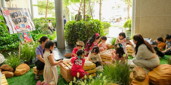 Children playing and learning outdoors with adults.