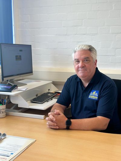 Man sitting at office desk with computer.