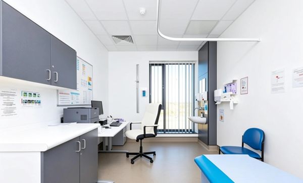 Bright, clean medical examination room with modern furnishings.