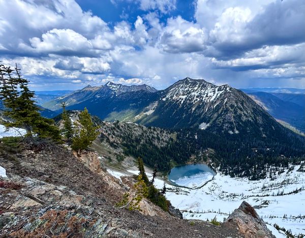 view of Hopkins Lake from above
Sky blue with big dynamic clouds
Mountains & Canada in the distance
