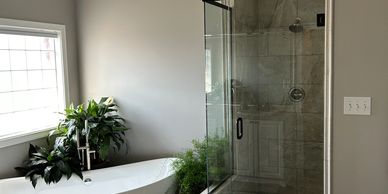 Modern bathroom with bathtub and glass shower.