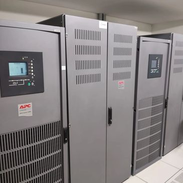 A row of APC Galaxy 5000 server racks in a data center room.