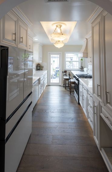 Bright, modern galley kitchen with white cabinetry.