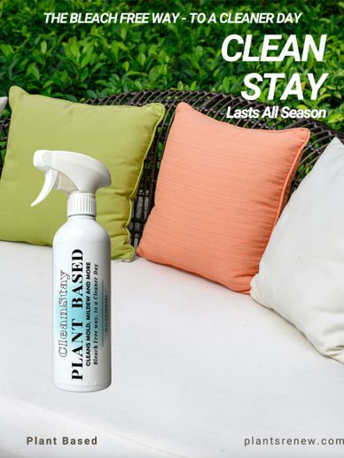 Plant-based cleaner spray on a white couch with colorful cushions.
