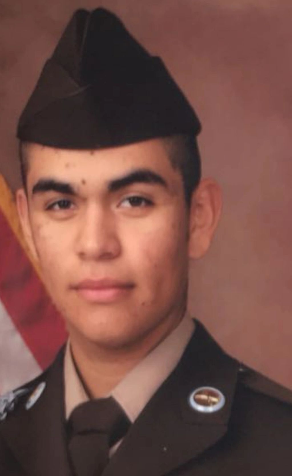 Young soldier in uniform posing for a formal portrait.