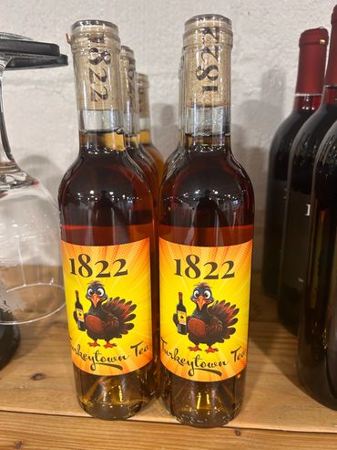Two bottles of 1822 Turkeytown Tea with a cartoon turkey holding a bottle.