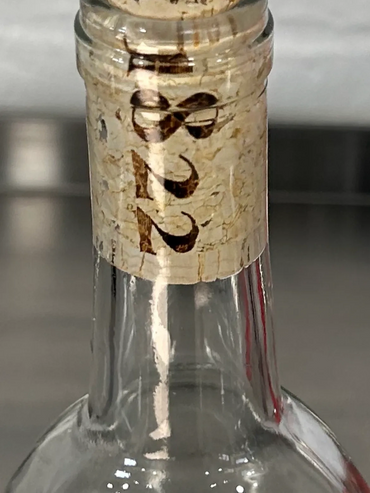 Close-up of a wine bottle cork with the year 1922 printed on it.