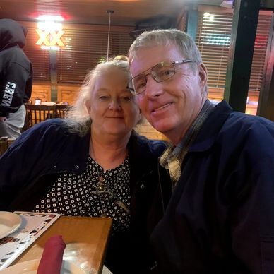 Smiling couple enjoying a cozy dinner at a restaurant.