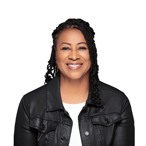 Smiling woman with braided hair in a black jacket on white background.