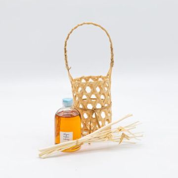 A reed diffuser set with bottle and basket.