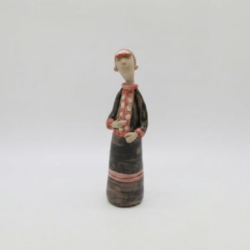 Ceramic figurine of a person in black and red attire.