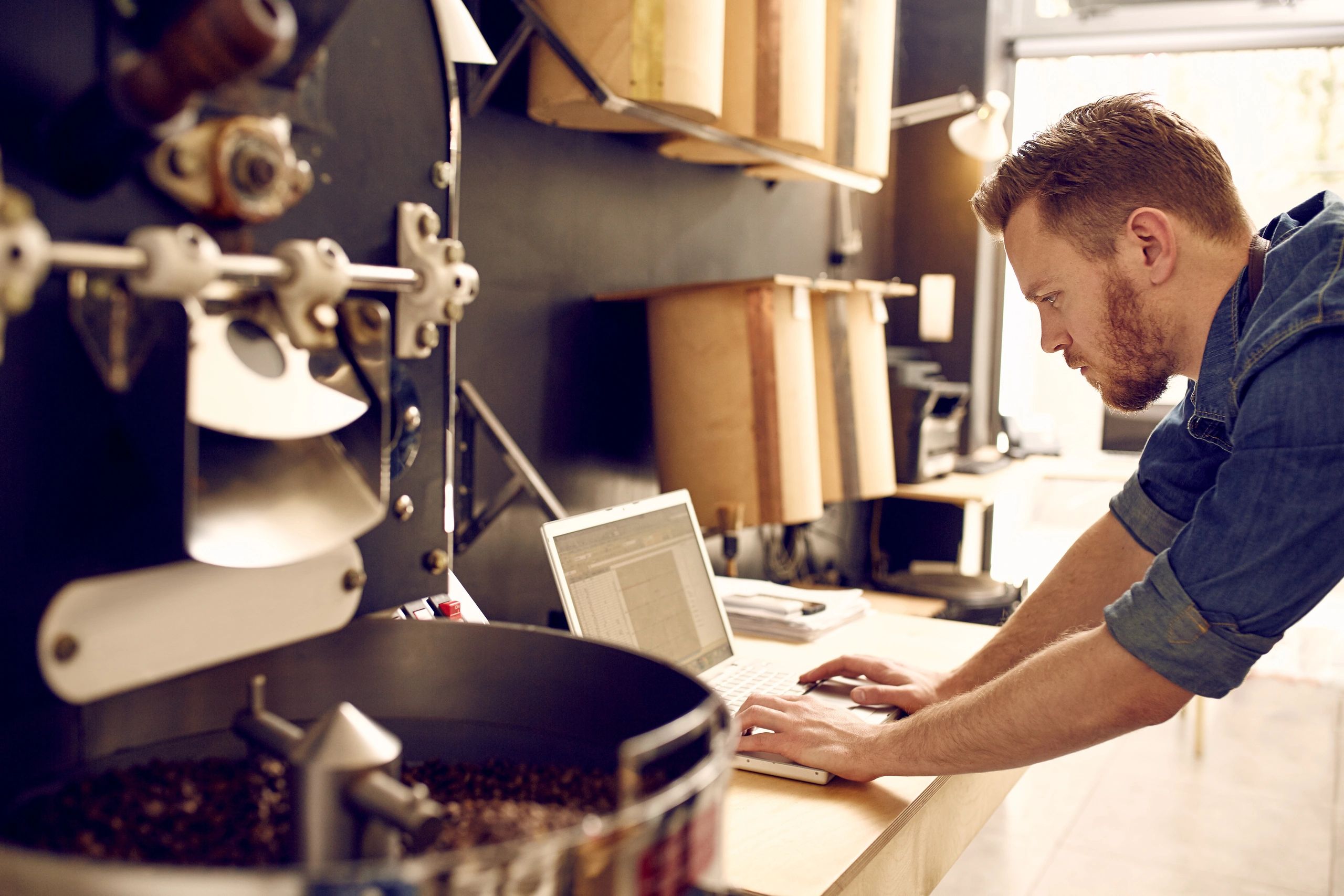 Man with coffee business on  a computer 