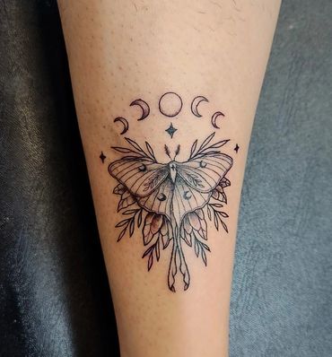 Moth with moon phases tattoo.