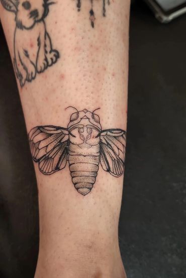 Realistic bee tattoo on forearm.