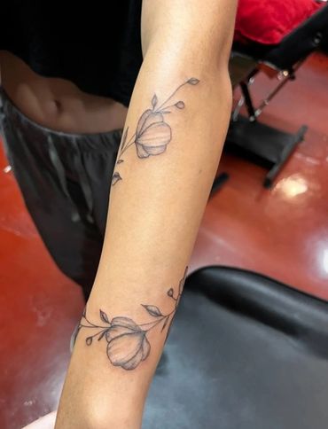 Dainty wildflower sprigs on forearm.