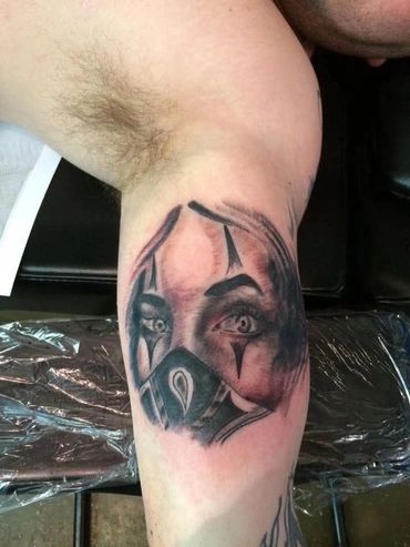 Masked woman with clown makeup tattoo.