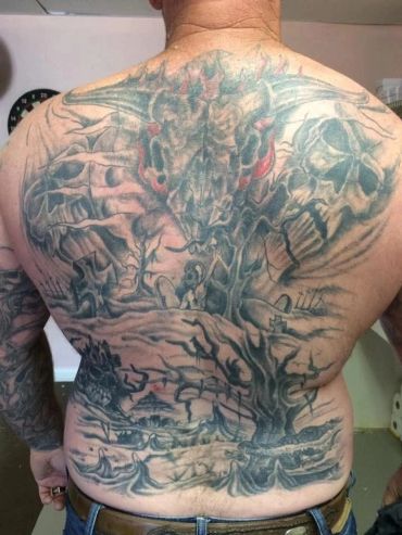 Full back landscape scene tattoo.