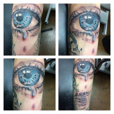 Grid of blue eye with blood tattoo.