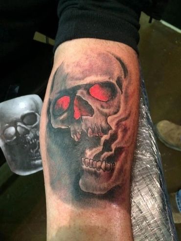 Skulls with red eyes and smoke tattoo.