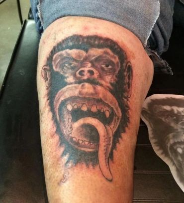 Angry chimpanzee face tattoo.