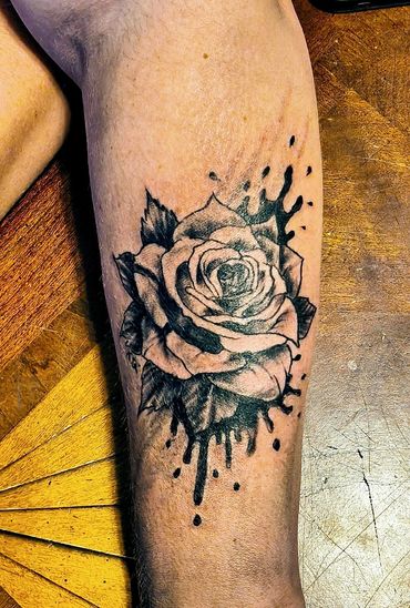 Rose with black ink splatters.