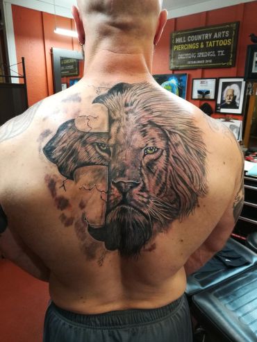 Lion head back tattoo.