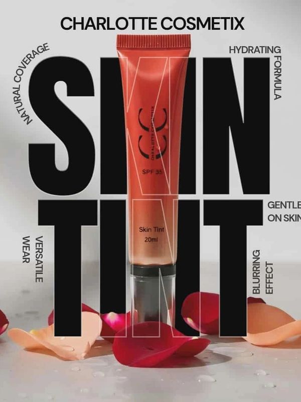Charlotte Cosmetix Skin Tint tube with rose petals and product benefits in bold text.