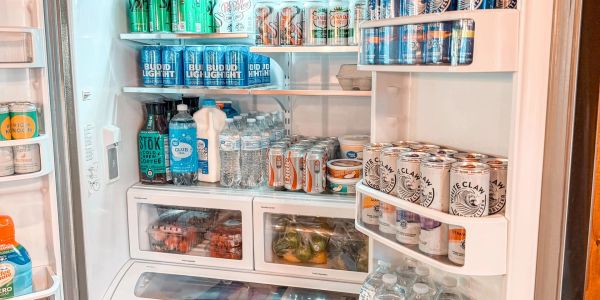 Organized fridge stocked with beverages and snacks.