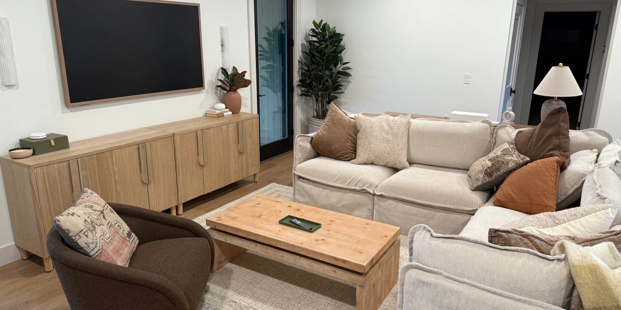 Cozy living room with neutral tones and wooden furniture.