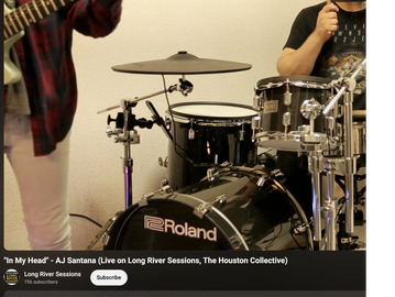 Drum set and musicians preparing to play.