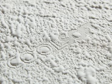 close-up image of a cool-touch cover on a 2'' memory foam