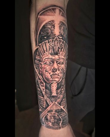 Tattoo of an Egyptian pharaoh and pyramids on forearm.