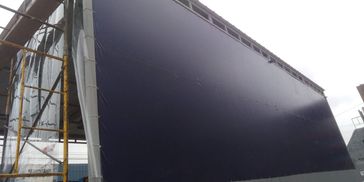 Large empty billboard under construction outside a building.
