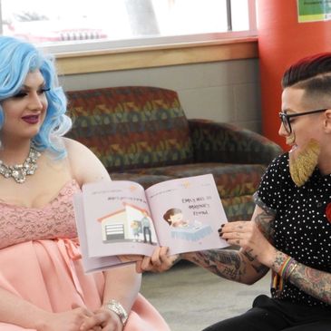 Two individuals reading a children's book together indoors.